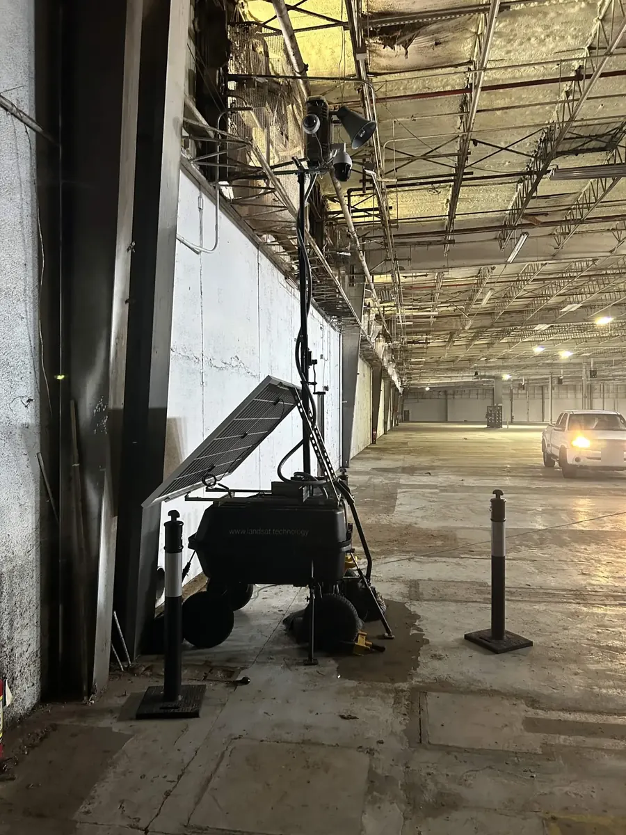 LOBO inside an empty warehouse with a damaged ceiling, with a pickup parked inside.