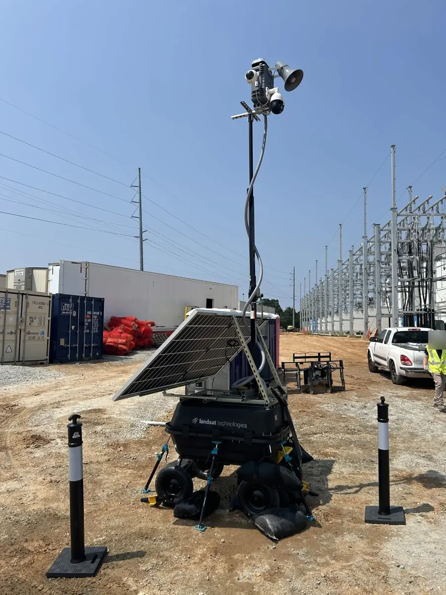 LOBO unit 93 by shipping containers, with a substation's steel and cables behind it.