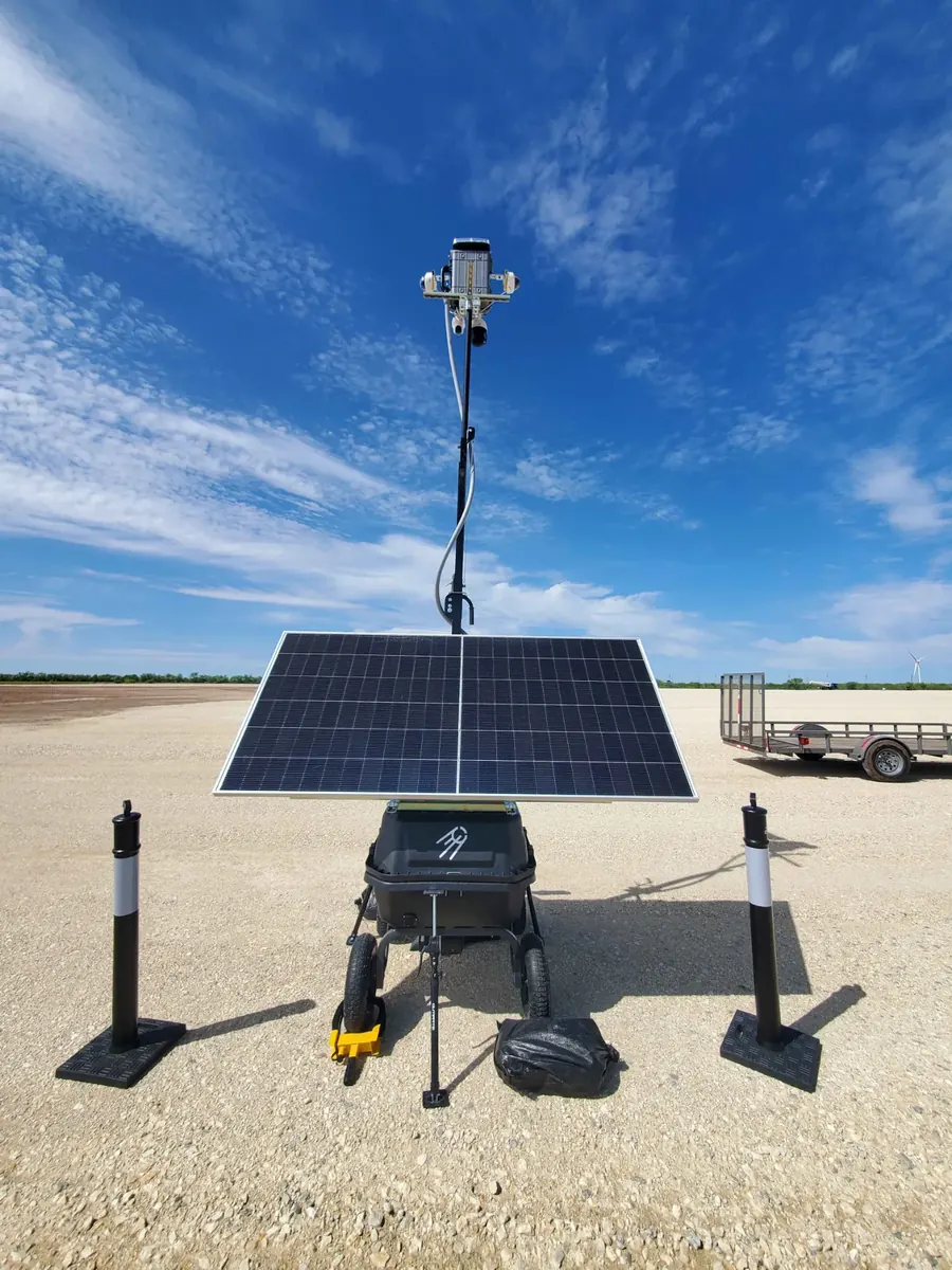 LOBO from the front on a laydown yard: solar panel, equipment box with the Landsat mark, cameras on the mast.