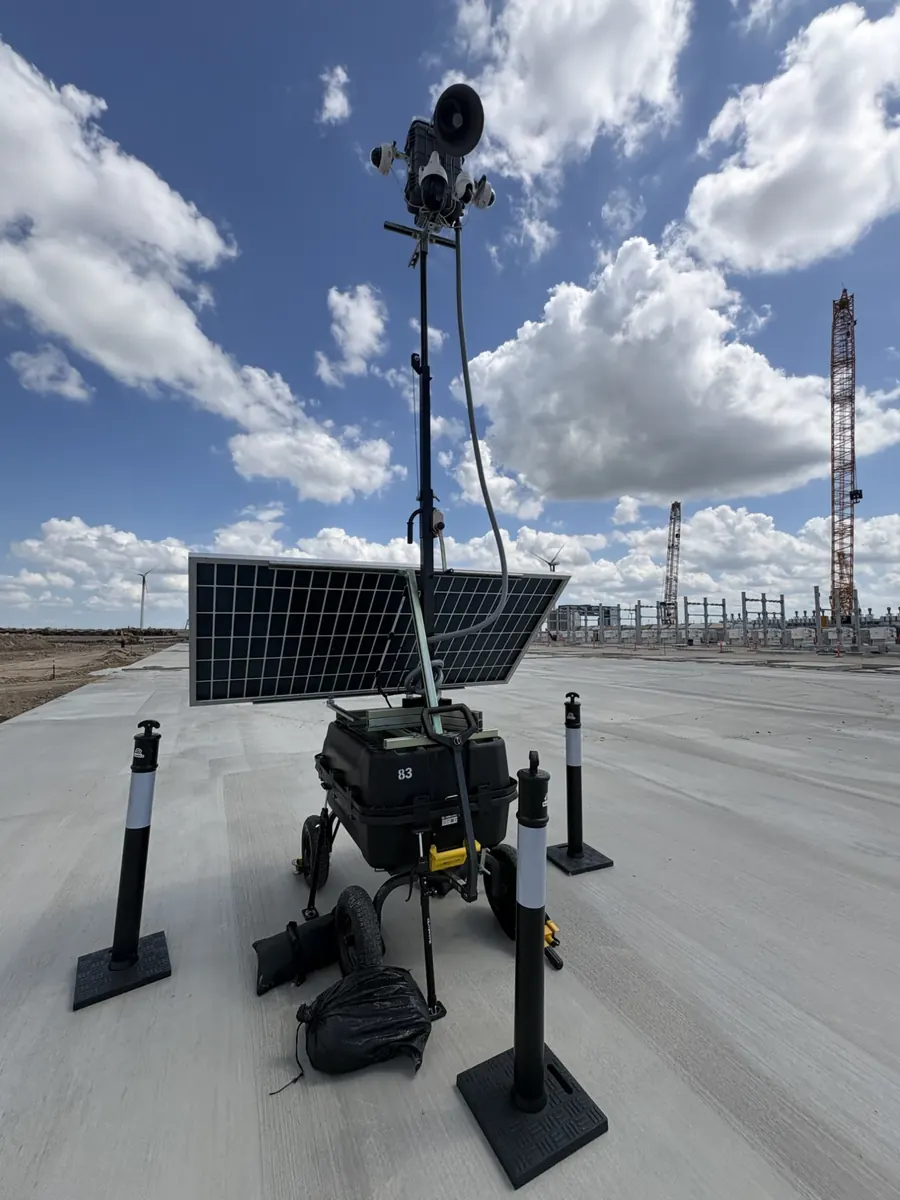 LOBO unit 83 on a new concrete pad, with cranes, wind turbines and electrical structures in the distance.
